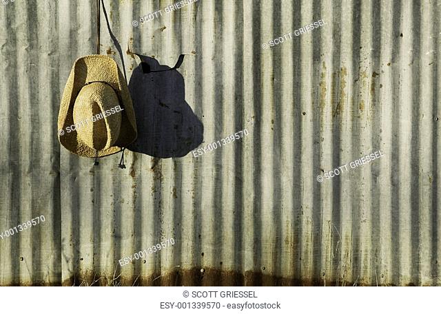 Cowboy hat against corrugated metal