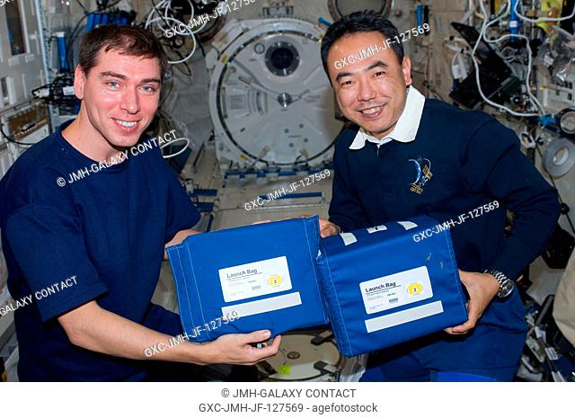 Russian cosmonaut Sergei Volkov (left) and Japan Aerospace Exploration Agency astronaut Satoshi Furukawa, both Expedition 28 flight engineers