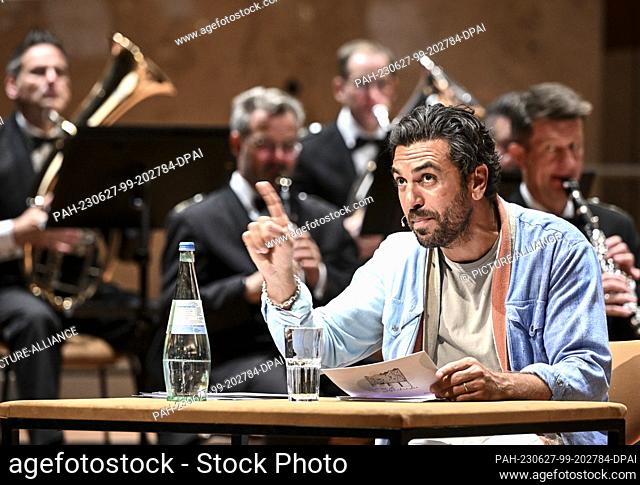 27 June 2023, Berlin: Actor Elyas M'Barek reads from ""Emil and the Detectives"" at a concert by the German Armed Forces Music Corps for schoolchildren at the...