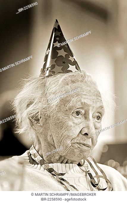Old woman wearing a party hat, portrait