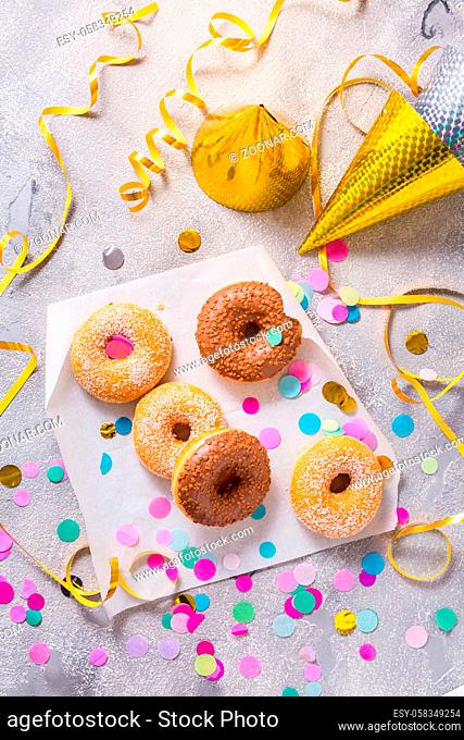 Donuts for carnival and party. Donuts with streamers and confetti. Colorful carnival or birthday image