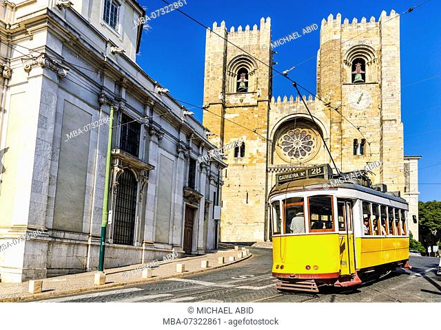 Historic yellow tram in front of the Lisbon Cathedral, Portugal