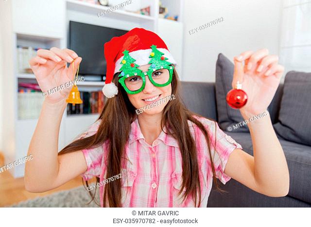 Christmas portrait of happy beautiful woman with Xmas decoration at home