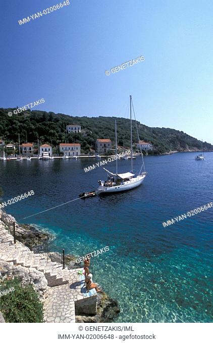 Kioni, sailboat, tourists sitting near the sea Ithaki, Ionian Islands, Greece
