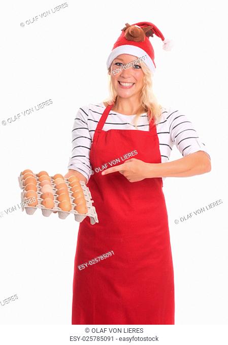 woman with santa hat and apron holding a palette eggs