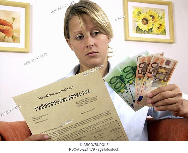 Woman with policy of liability insurance and euro notes