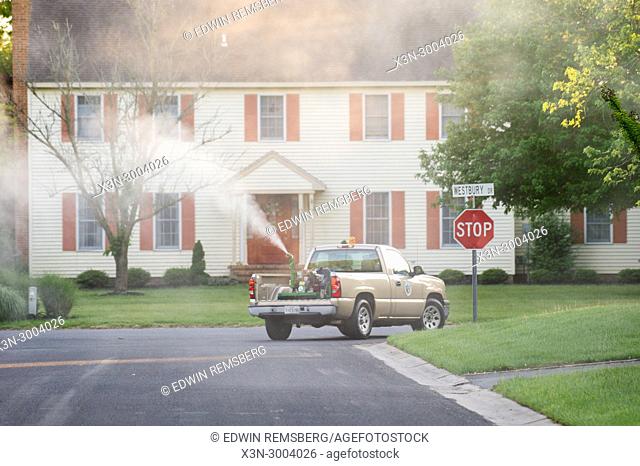 Salisbury Maryland USA - Mosquito Control Truck drives through suburban neighborhood spraying insecticide to control mosquito population