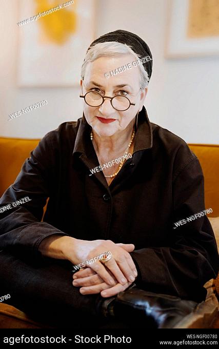 Smiling senior woman wearing eyeglasses at home
