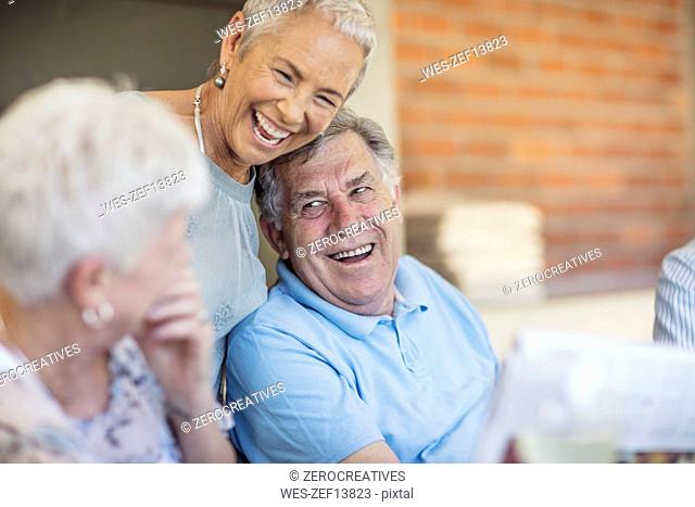 Portait of smiling senior man having fun with his friends