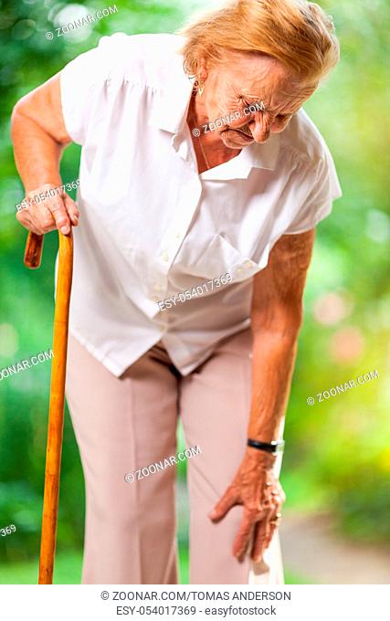 Elderly woman in the 80s with a walking stick