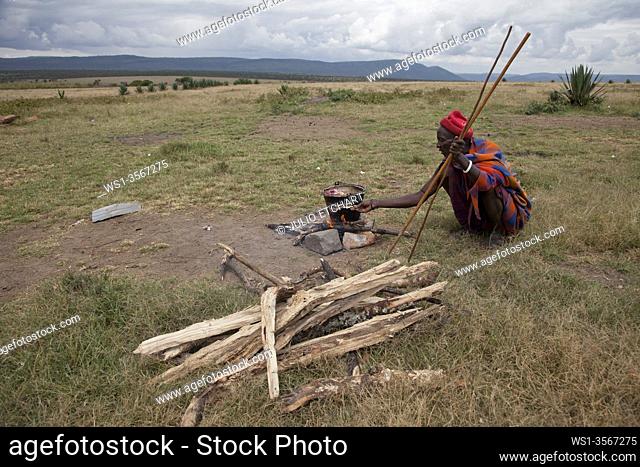 Masai clan cutting, cooking and eating a goat in Siana , next to the Masai Mara Nature Reserve, Kenya
