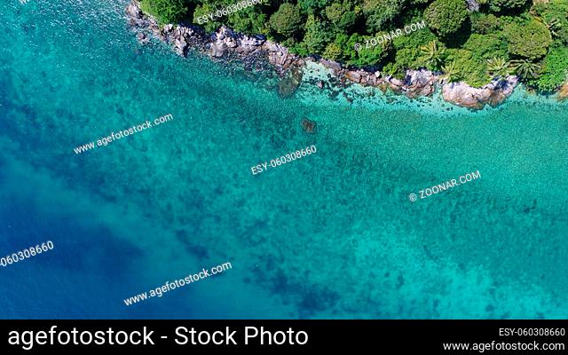 Aerial drone view of beautiful island coastline with rocks and transparent sea water around in sunny summer day