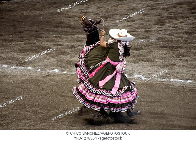 An Amazona rides her horse at an Escaramuza competition in Mexico City. Escaramuzas are similar to US rodeos, where female competitors called 'Amazonas' wear...