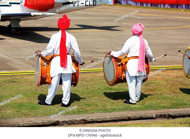 Drum beaters welcoming the inaugural flight at aamby valley airport , Lonavala , Maharashtra , India