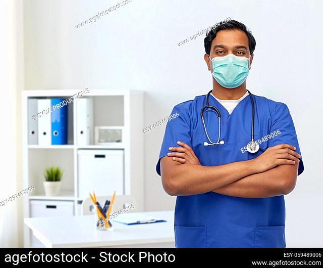 indian male doctor in blue uniform and mask