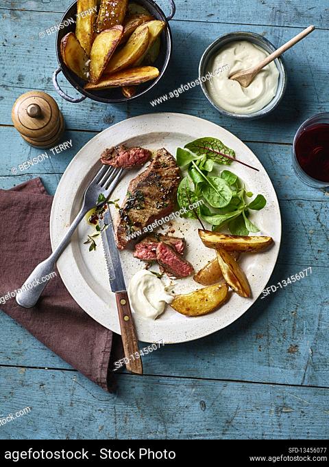Seared steak with garlic tofu 'mayo' and potato wedges
