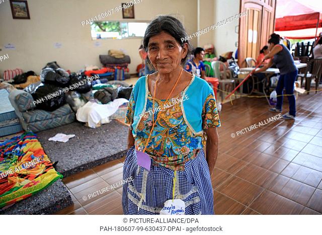 07 June 2018, Guatemala, Escuintla: Angela Alvarado (71) smiles as she stands in a hall at the emergency and evacuation shelter after the volcano eruption in...
