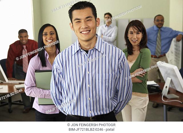 Businessman with coworkers in background