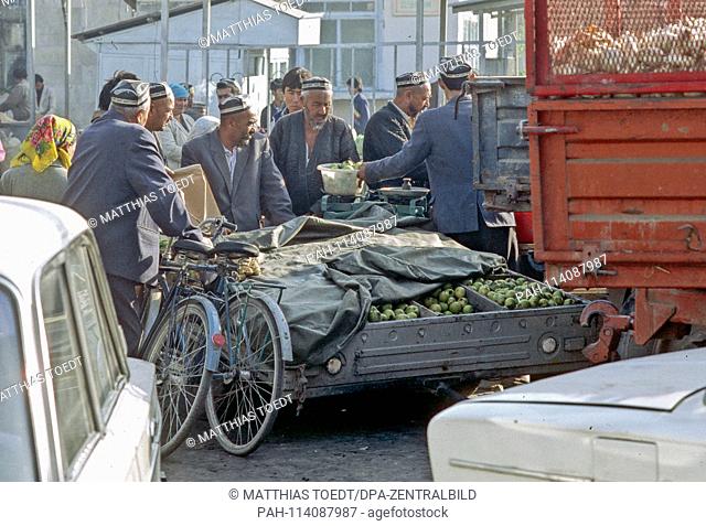 In the market of Khiva apples are offered for sale by a car trailer, analogue and undated recording of October 1992. Khiva was for centuries a preying Islamic...