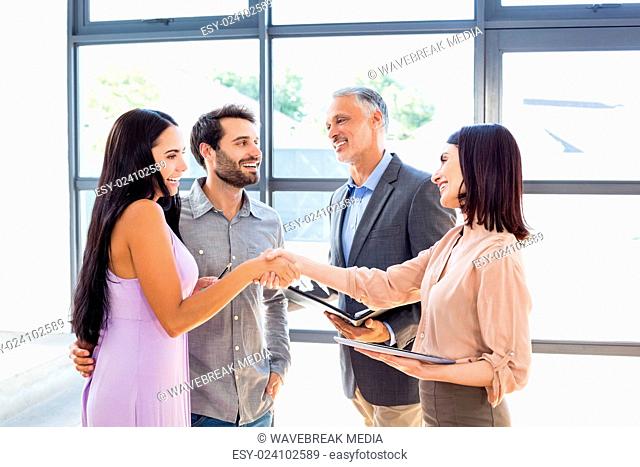 Couple shaking hand with real estate agent