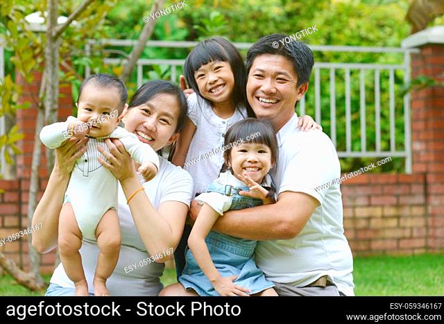 Portrait of happy asian family playing In garden.Concept of family relaxation