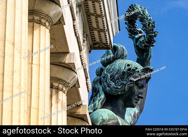 18 May 2022, Bavaria, Munich: The 18-meter-high Bavaria statue, which stands above the Oktoberfest grounds, rises into the sky against a blue sky on the stone