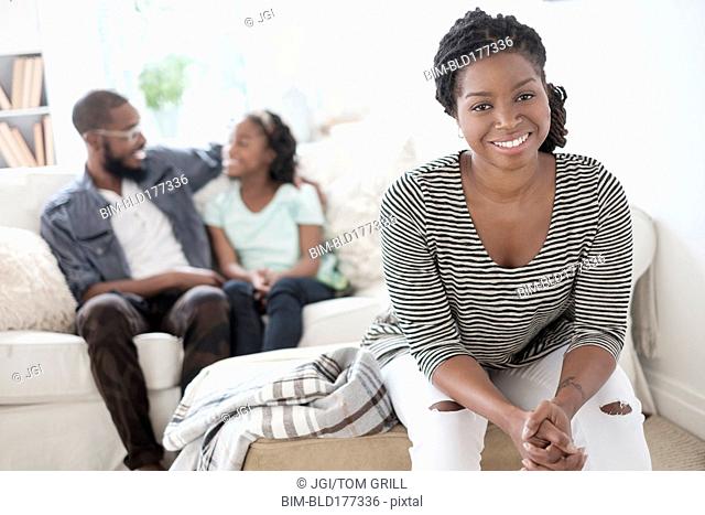 Black mother sitting in living room