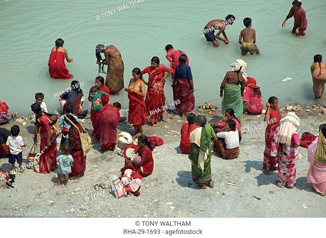 Ritual cleansing in Seti Khola, a tributary of the Ganges, for Nepali New Year, Pokhara, Nepa, Asia