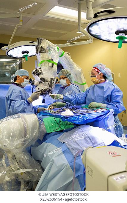 Englewood, Colorado - Dr. Paul Elliott (left) performs minimally invasive lumbar spine surgery on a patient at Swedish Medical Center