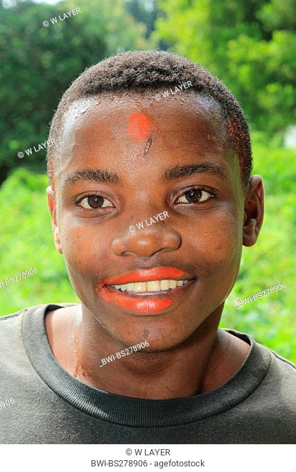 Achiote, Annatto, Lipstick Tree, Urucum Bixa orellana, man with lips coloured by annatto, Tanzania, Sansibar