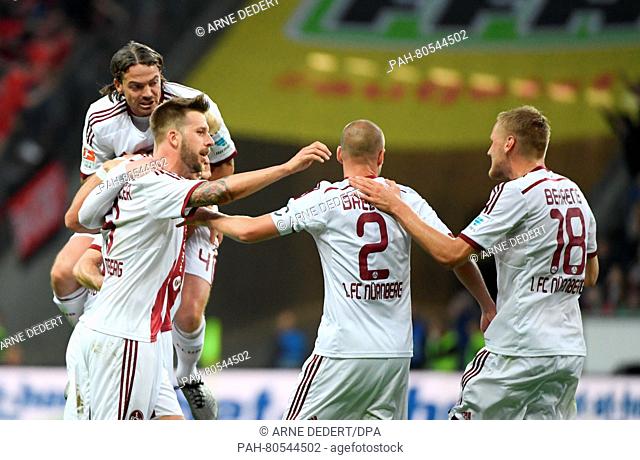 Nuremberg's David Bulthuis (L-R), Guido Burgstaller, Miso Brecko and Hanno Behrens cheer after their 1-0 goal during the German Bundesliga relegation match in...