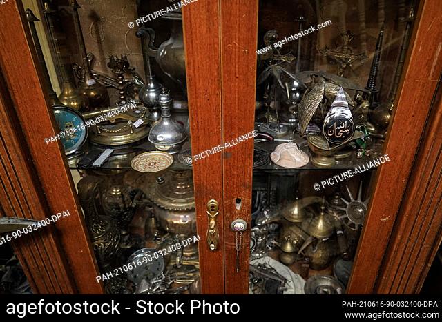 16 June 2021, Iraq, Mosul: A general view of a cabinet packed with antique pieces collected by Iraqi Fakhri Suleiman Al-Tai after he returned to his house at...