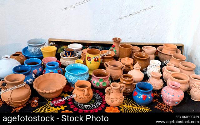lots of beautifully decorated clay pots. children's crafts