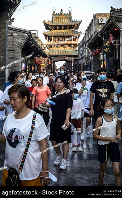 Tourists walk down the pedestrian street at old town of Pingyao, China on 31/07/2021 Acient city and the walls of the town are the UNESCO World Heritage Site by...