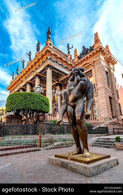 Guanajuato, Mexico - February 26, 2020: La Giganta bronze sculpture by Jose Luis Cuevas with Juarez Theater in the background