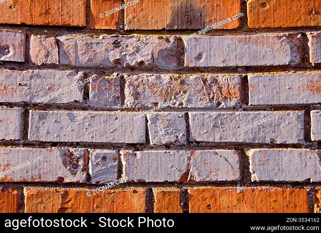 Wall made of red and colored bricks. Architectural decision