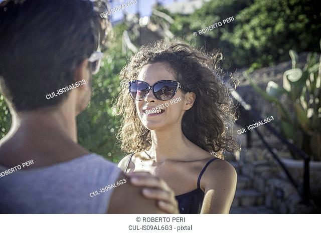 Couple in sunlight, woman wearing sunglasses