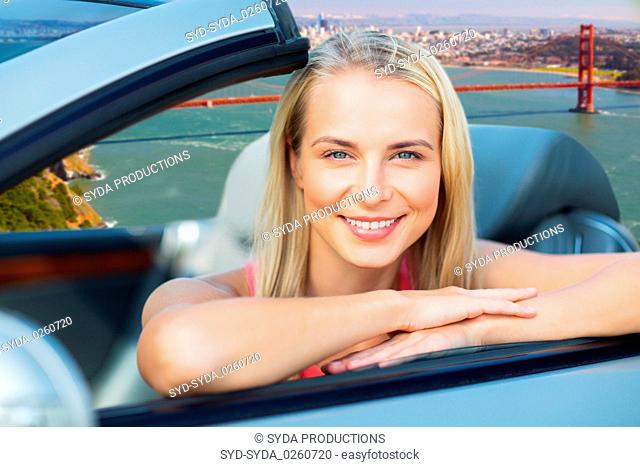 woman in convertible car over golden gate