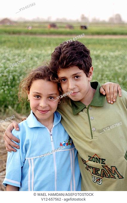 Egyptian Village boy & girl at wheat harvest time in Monofeya Governorate is one of the Egyptian Governorates