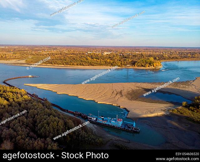 Cleaning and deepening by a dredger on the river. Ob river, Siberia, Russia