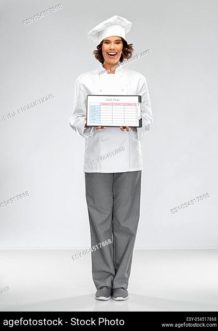 smiling female chef holding with diet plan