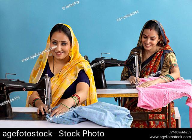 Two rural women working on sewing machines