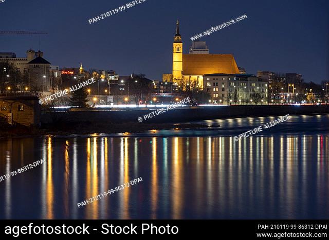 18 January 2021, Saxony-Anhalt, Magdeburg: The Elbe promenade with the Johanniskirche at the blue hour. The former church was destroyed and rebuilt several...