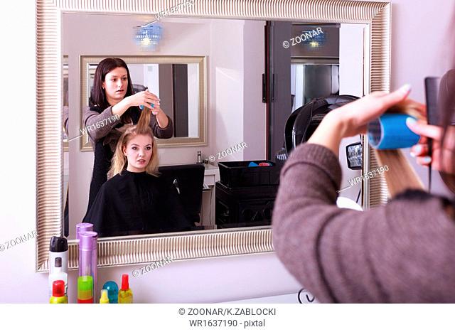Beautiful blond girl hair curlers rollers hairdresser beauty salon