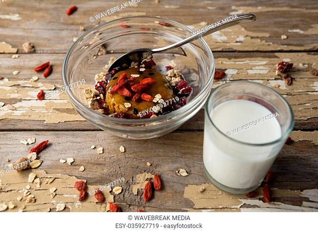 Breakfast cereals and milk on wooden table
