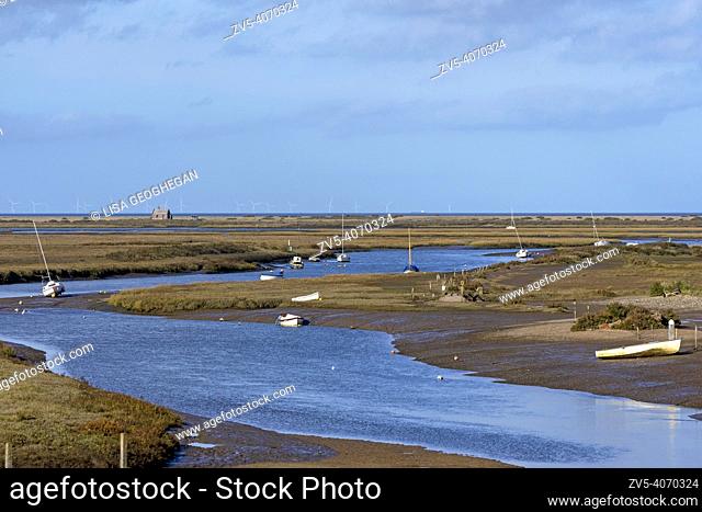 Marshes and river Glaven in Blakeney National Nature Reserve with Race Bank Wind Farm situated beyond the horizon in the Norh Sea, Norfolk, England