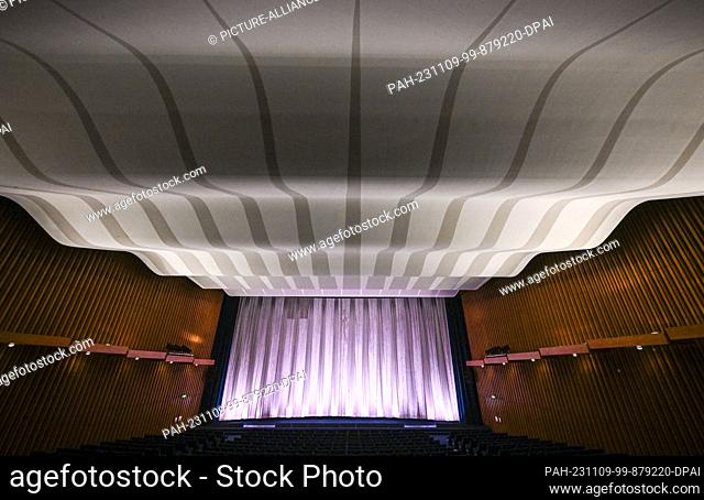 08 November 2023, Berlin: During a press tour of Kino International on Karl-Marx-Allee, the auditorium with the curtain in front of the movie screen and the...