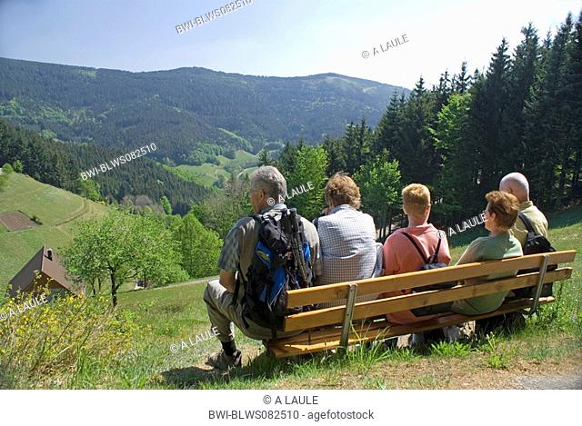 group of hiker sitting on a bench enjoying the view, Germany, Baden-Wuerttemberg, Black Forest