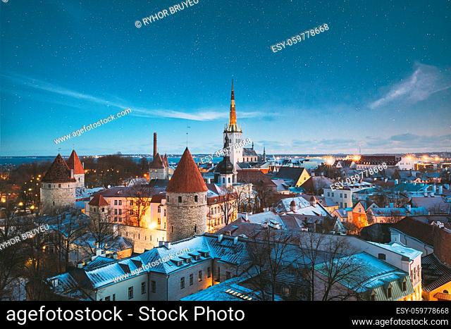 Tallinn, Estonia. Night Starry Sky Above Old Castle Walls Architecture. Cityscape Skyline In Old Town. Winter Evening Night. Famous Landmark