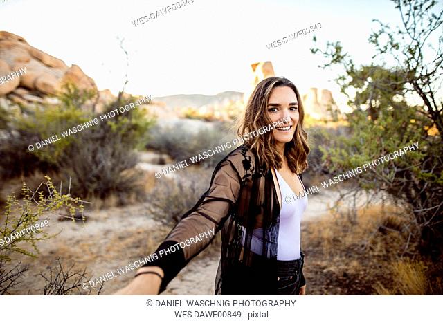USA, California, Los Angeles, portrait of smiling woman in Joshua Tree National Park